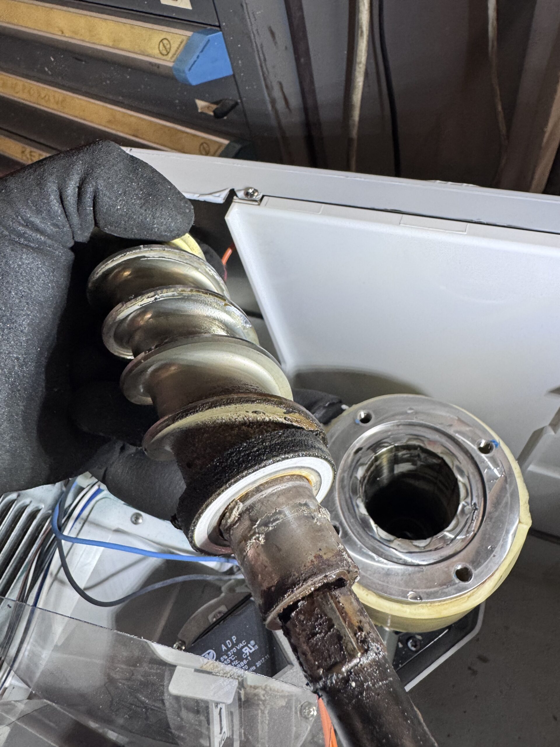 Bottom of Scotsman SCN60 auger shaft showing calcium deposits and failed seal remnants - Houston ice maker repair